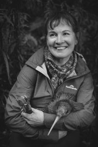 Artist Dr. Liz Grant holds a kiwi.