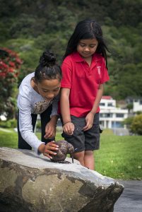 Kids enjoy one of the new kiwi sculptures on the Kiwi Wandering Trail.