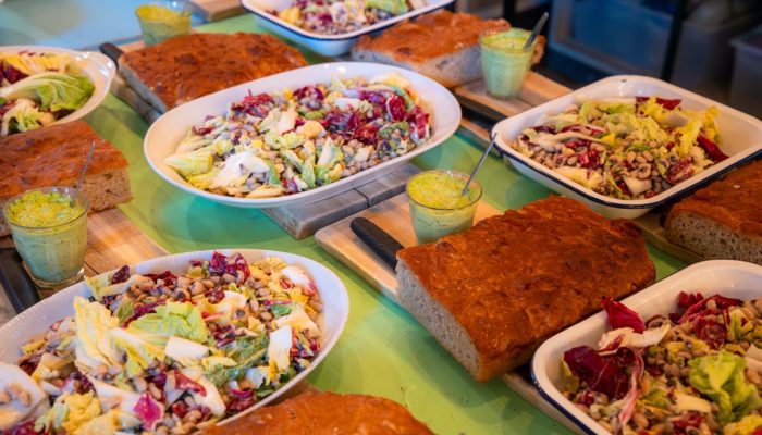 Loaves of bread and brightly coloured bowls of salad