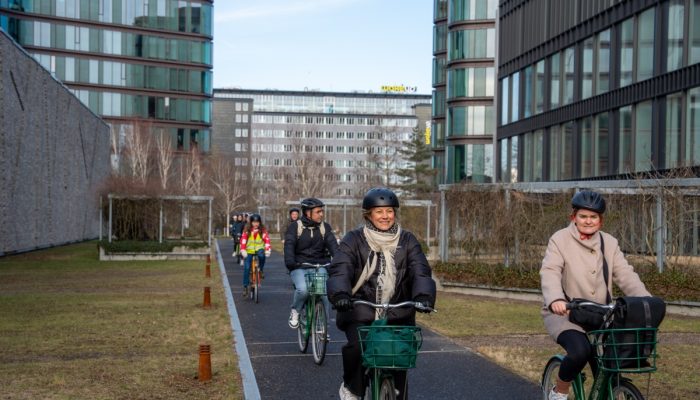 Cyclists ride toward the camera.