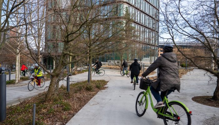 Cyclists navigate a twisty sidewalk.
