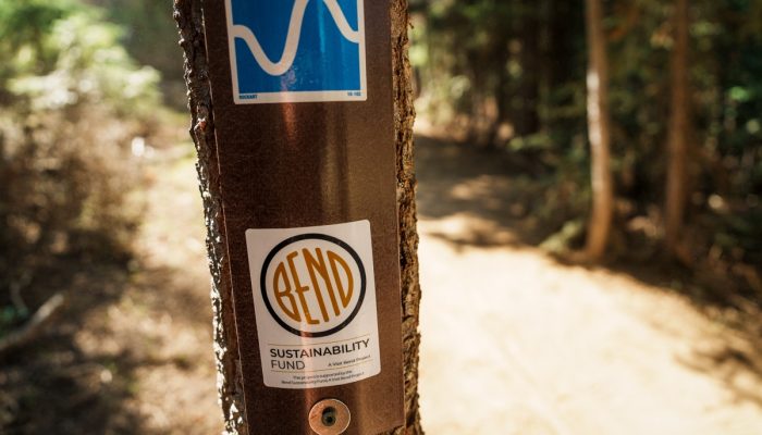 A lightpost carries a sticker: "Bend Sustainability Fund"